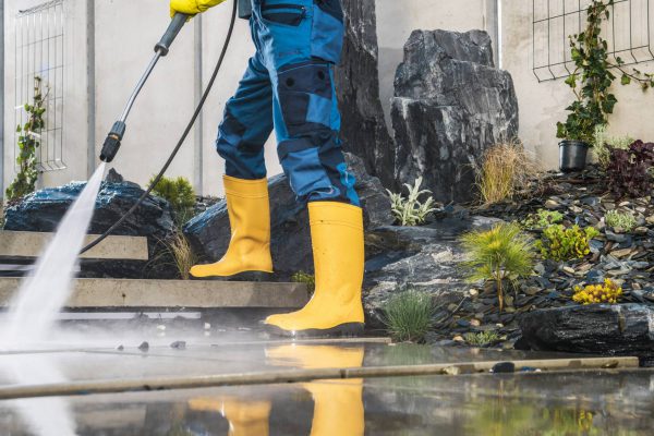 men-pressure-washing-his-garden-architectural-conc-2022-12-16-11-45-44-utc